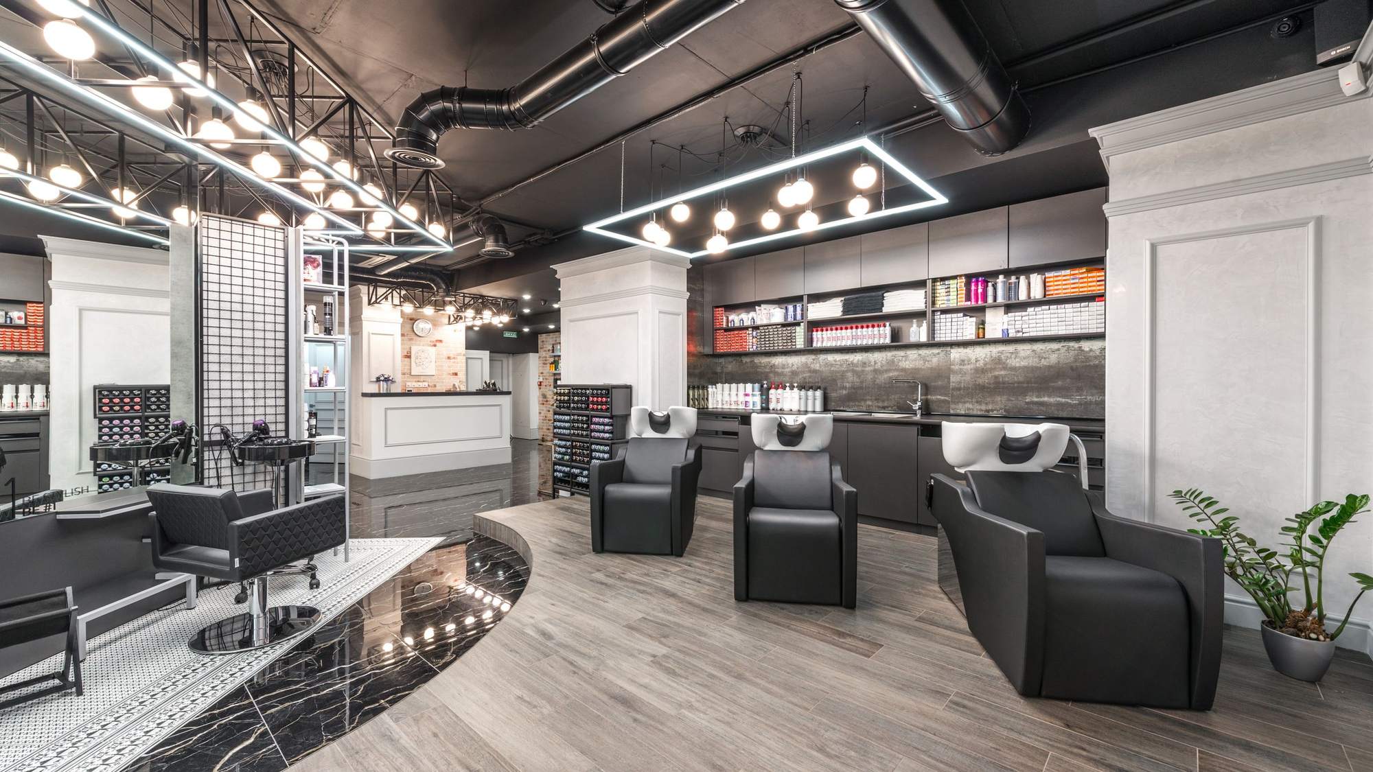 A hair salon with black wash chairs and sinks